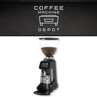 Coffee grinder with coffee beans on a white background, featuring the Coffee Machine Depot logo.