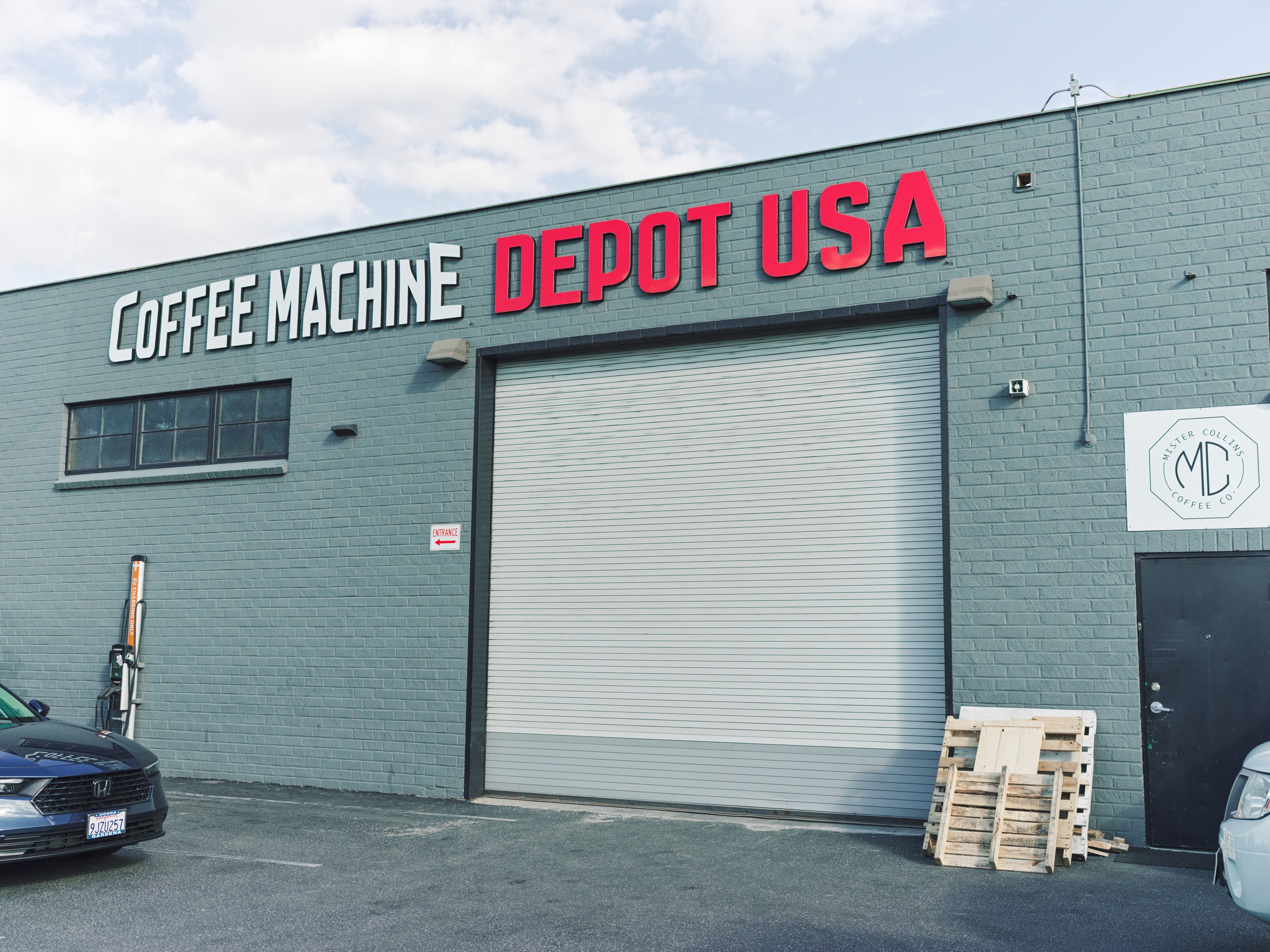 Building exterior with 'Coffee Machine Depot USA' sign on a clear day