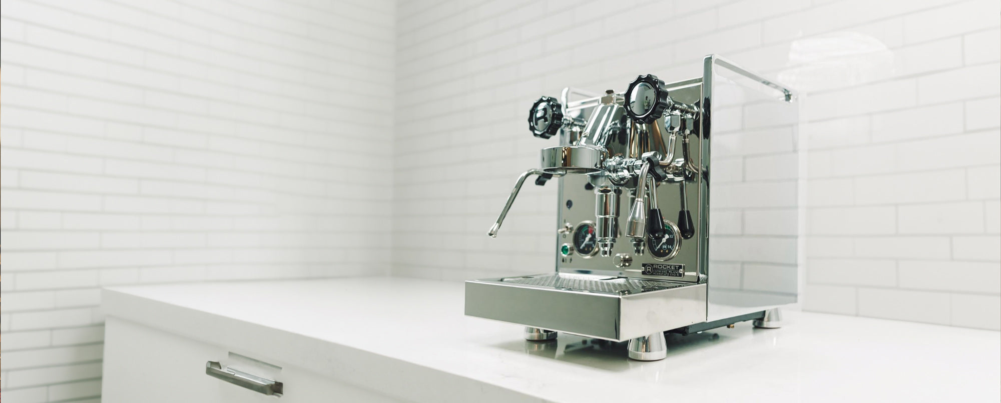 Rocket Espresso machine on a clean white countertop in a modern kitchen, ideal for home baristas and espresso enthusiasts.
